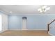 Bright and airy living area featuring tile floors, light blue walls, and access to the staircase at 7911 Hampton Lake Dr, Tampa, FL 33647