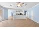 Spacious living area featuring a kitchen bar, tile flooring, neutral walls, and backyard access at 7911 Hampton Lake Dr, Tampa, FL 33647