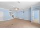 Light-filled living room with staircase to the second level, tile flooring and an open layout at 7911 Hampton Lake Dr, Tampa, FL 33647