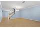 Expansive living space with tile flooring, staircase, and light blue walls at 7911 Hampton Lake Dr, Tampa, FL 33647