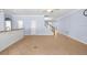 Expansive living room area with tile flooring, neutral paint, with bar and staircase nearby at 7911 Hampton Lake Dr, Tampa, FL 33647