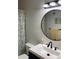 Updated bathroom features a modern vanity, round mirror, and a charming starfish shower curtain at 7951 58Th N Ave # 308, St Petersburg, FL 33709