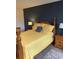 Comfortable bedroom featuring warm yellow tones, a stylish bed, and wood furnishings at 7951 58Th N Ave # 308, St Petersburg, FL 33709