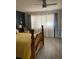 Comfortable bedroom features an oak bed frame, a ceiling fan and natural light through the windows at 7951 58Th N Ave # 308, St Petersburg, FL 33709