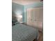 Comfortable bedroom featuring a cozy bed, soft lighting, and ample closet space at 7951 58Th N Ave # 308, St Petersburg, FL 33709