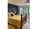 Cozy bedroom with a striking navy accent wall, wooden furniture, and plenty of natural light at 7951 58Th N Ave # 308, St Petersburg, FL 33709