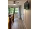 Bright bedroom with a TV, light gray floors, and a door leading to the exterior at 7951 58Th N Ave # 308, St Petersburg, FL 33709