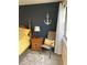 Well-lit bedroom with a wooden bed frame and nautical anchor wall decor at 7951 58Th N Ave # 308, St Petersburg, FL 33709