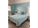 Serene bedroom with a queen bed and a coastal inspired blue and white patterned comforter and pillows at 7951 58Th N Ave # 308, St Petersburg, FL 33709