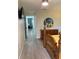 Spacious bedroom with an en suite, light gray floors, wood furnishings, and a decorative mirror at 7951 58Th N Ave # 308, St Petersburg, FL 33709