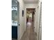 Hallway view showcasing the bathroom with a blue vanity, leading into a bedroom with natural light at 7951 58Th N Ave # 308, St Petersburg, FL 33709