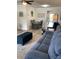 This open-concept living room has a ceiling fan, new floors, modern furnishings, and adjoins the dining and kitchen area at 7951 58Th N Ave # 308, St Petersburg, FL 33709