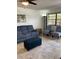 Comfortable living room with a plush sofa, patterned chairs, accent tables, new floors, and a large window for ample natural light at 7951 58Th N Ave # 308, St Petersburg, FL 33709