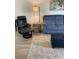 This living room features a recliner, plush sofa, new floors, accent tables, and decorative lighting for a welcoming space at 7951 58Th N Ave # 308, St Petersburg, FL 33709