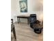 This living room features an accent table, comfy leather recliner, new floors, and an art piece for a relaxing space at 7951 58Th N Ave # 308, St Petersburg, FL 33709