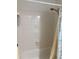 The bathroom features a bright white shower with white tiles, shower head, faucet and soap dish at 7951 58Th N Ave # 308, St Petersburg, FL 33709