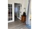 Cozy seating area with hardwood flooring and a table with a lamp, flowing to a covered patio at 7951 58Th N Ave # 308, St Petersburg, FL 33709