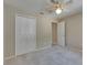 Neutral bedroom featuring plush carpet and a ceiling fan for added comfort at 812 Amethyst Way, Valrico, FL 33594