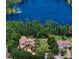 Luxury estate overlooking a pristine blue lake surrounded by lush green trees at 1102 Merry Water Dr, Lutz, FL 33548