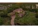 Expansive estate with lush landscaping, a circular driveway, and a tile roof at sunset at 1102 Merry Water Dr, Lutz, FL 33548