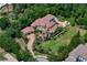 Aerial view of a beautiful home with an outdoor pool, sun loungers, and a meticulously manicured lawn at 1102 Merry Water Dr, Lutz, FL 33548