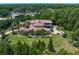 An aerial view showcases the home with pool, outdoor seating, mature trees, and extensive landscaping at 1102 Merry Water Dr, Lutz, FL 33548
