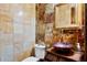 Elegant powder room with colorful decorative tile, unique copper colored sink, and decorative mirror at 1102 Merry Water Dr, Lutz, FL 33548