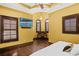 Inviting bedroom with hardwood floors, tray ceiling, and a wall-mounted TV at 1102 Merry Water Dr, Lutz, FL 33548