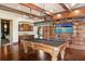 Game room with built-in bar, pool table, wood floors, and access to the bedroom at 1102 Merry Water Dr, Lutz, FL 33548