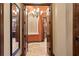 Elegant hallway featuring stone floors, arched doorways, and decorative lighting at 1102 Merry Water Dr, Lutz, FL 33548