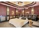Home theater with a large bed, comfortable seating, projector, and tiered ceiling for a luxury viewing experience at 1102 Merry Water Dr, Lutz, FL 33548