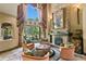 Elegant living room with stone fireplace, large windows, and luxurious seating arrangement at 1102 Merry Water Dr, Lutz, FL 33548