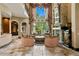 Elegant living room with stone fireplace, large windows, and luxurious seating at 1102 Merry Water Dr, Lutz, FL 33548