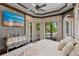 Opulent main bedroom with a decorative tray ceiling, hardwood floors, and outdoor views at 1102 Merry Water Dr, Lutz, FL 33548