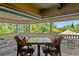 Covered outdoor seating area with elegant furniture, offering a relaxing space with views of nature at 1102 Merry Water Dr, Lutz, FL 33548