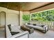 Covered outdoor space featuring comfortable seating around a fire pit, offering a relaxing entertainment area at 1102 Merry Water Dr, Lutz, FL 33548