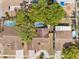 An aerial view of houses with pools, surrounded by lush trees, offering privacy and relaxation at 11318 Stoneybrook Path, Port Richey, FL 34668