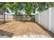 Backyard featuring a wood fence and large tree providing plenty of shade at 11318 Stoneybrook Path, Port Richey, FL 34668