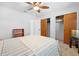 Well-lit bedroom with a ceiling fan, offering storage and a comfortable atmosphere at 11318 Stoneybrook Path, Port Richey, FL 34668