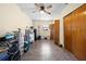 Bedroom features a ceiling fan, tile floors and a large closet for storage at 11318 Stoneybrook Path, Port Richey, FL 34668