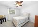 Cozy bedroom with light walls and a ceiling fan for temperature control at 11318 Stoneybrook Path, Port Richey, FL 34668