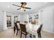 Bright dining room features tile flooring, modern ceiling fan, and French doors with backyard access at 11318 Stoneybrook Path, Port Richey, FL 34668