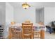 Bright dining room featuring a chandelier, wooden table, and four chairs at 11318 Stoneybrook Path, Port Richey, FL 34668