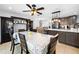 Spacious dining room features dark brown display cabinets and easy access to modern kitchen at 11318 Stoneybrook Path, Port Richey, FL 34668