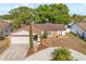 Charming single-story home with a stone accent, well-kept lawn, and a circular driveway at 11318 Stoneybrook Path, Port Richey, FL 34668