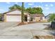Inviting home featuring a well-manicured lawn, charming stone details, and an attached two-car garage at 11318 Stoneybrook Path, Port Richey, FL 34668