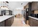 View of the kitchen with dark cabinets, a white countertop, and an adjacent dining area at 11318 Stoneybrook Path, Port Richey, FL 34668