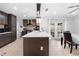 Spacious kitchen with dark cabinets, an island, and easy access to outdoor dining area at 11318 Stoneybrook Path, Port Richey, FL 34668