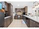 Fully equipped kitchen with dark cabinets, stainless appliances, and an island at 11318 Stoneybrook Path, Port Richey, FL 34668