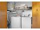 Bright laundry room featuring modern washer and dryer appliances at 11318 Stoneybrook Path, Port Richey, FL 34668